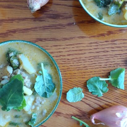 Two bowls of spicy sausage, potato and kale soup.