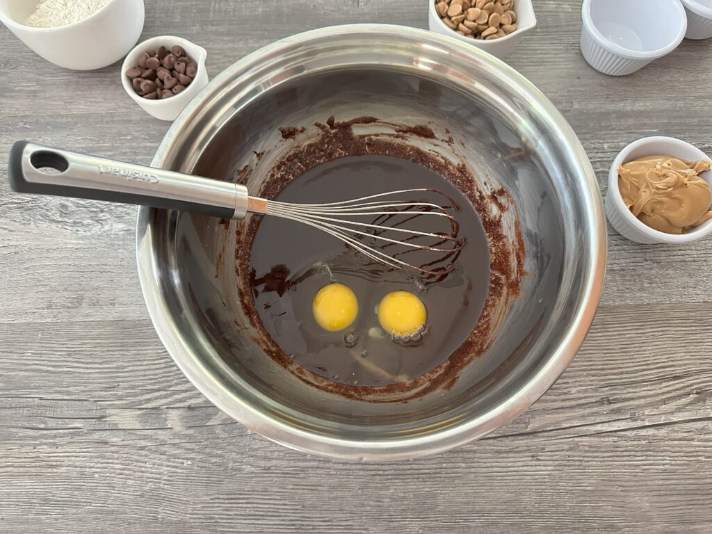 Eggs added to the butter/cocoa mixture.