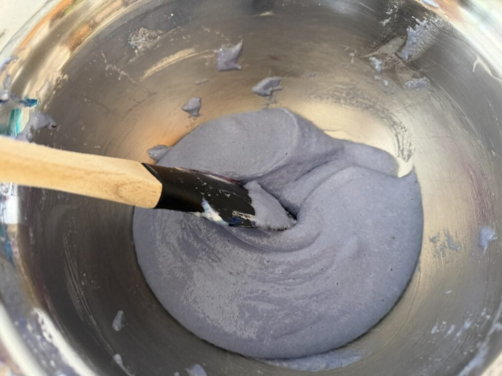 Dragging spatula through macaronage to help make a cohesive batter.