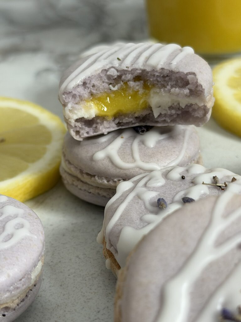 A bite taken out of a macaron to show the inside.