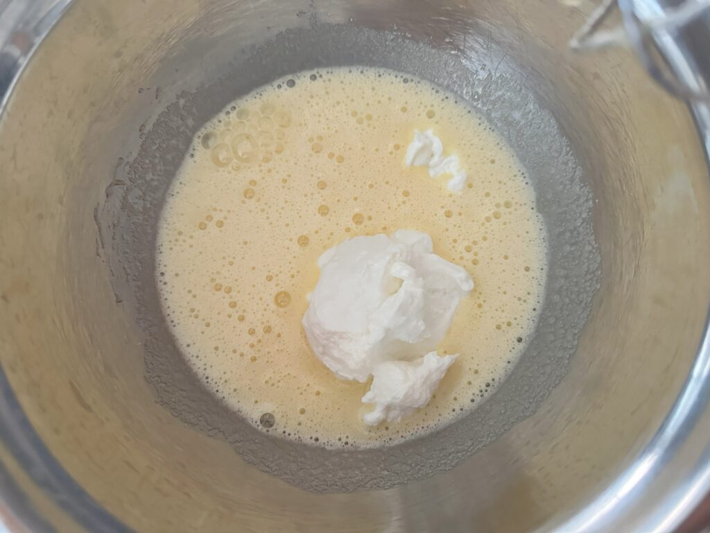 Eggs and sugar whipped together with sour cream, milk, vanilla extract, baking powder and salt added in.