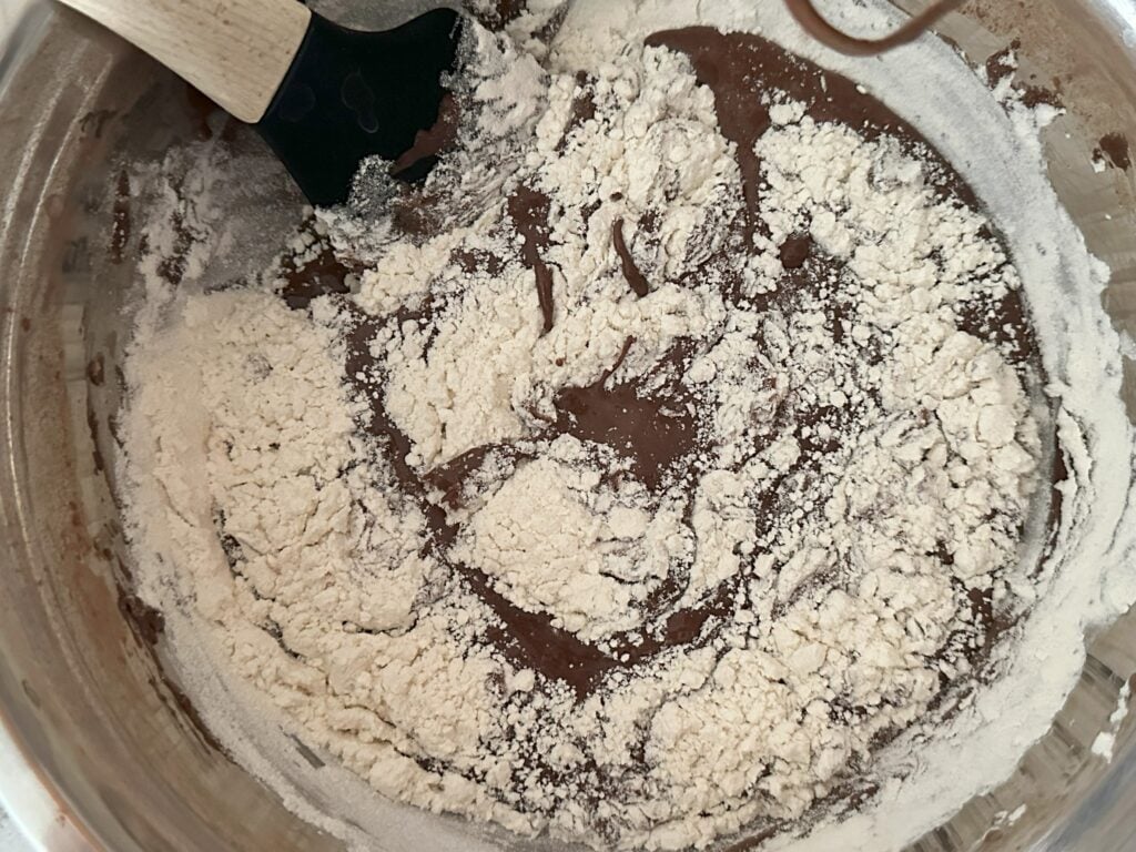 Flour being added into the batter.
