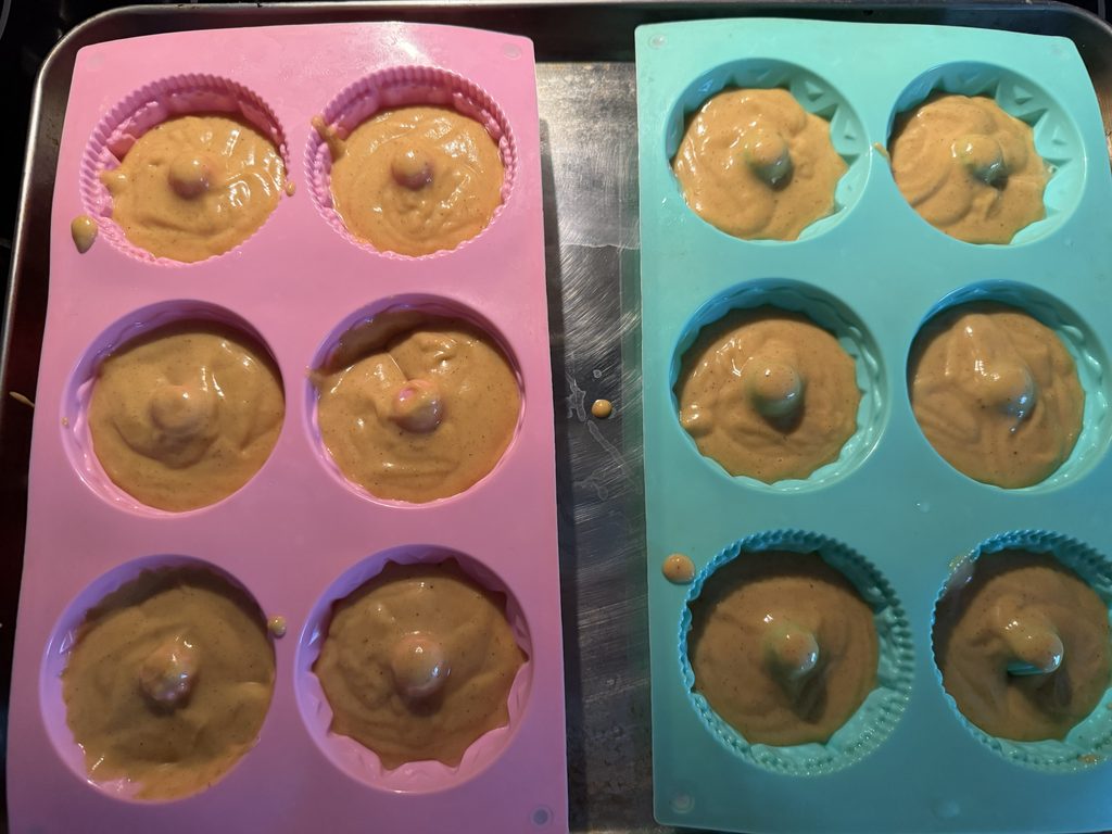 Completed batter poured into two mini Bundt cake silicone pans.