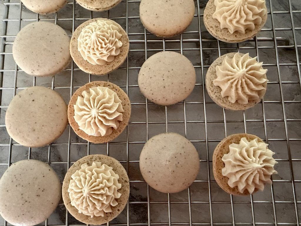 Open-faced macaron shells showing the filling.