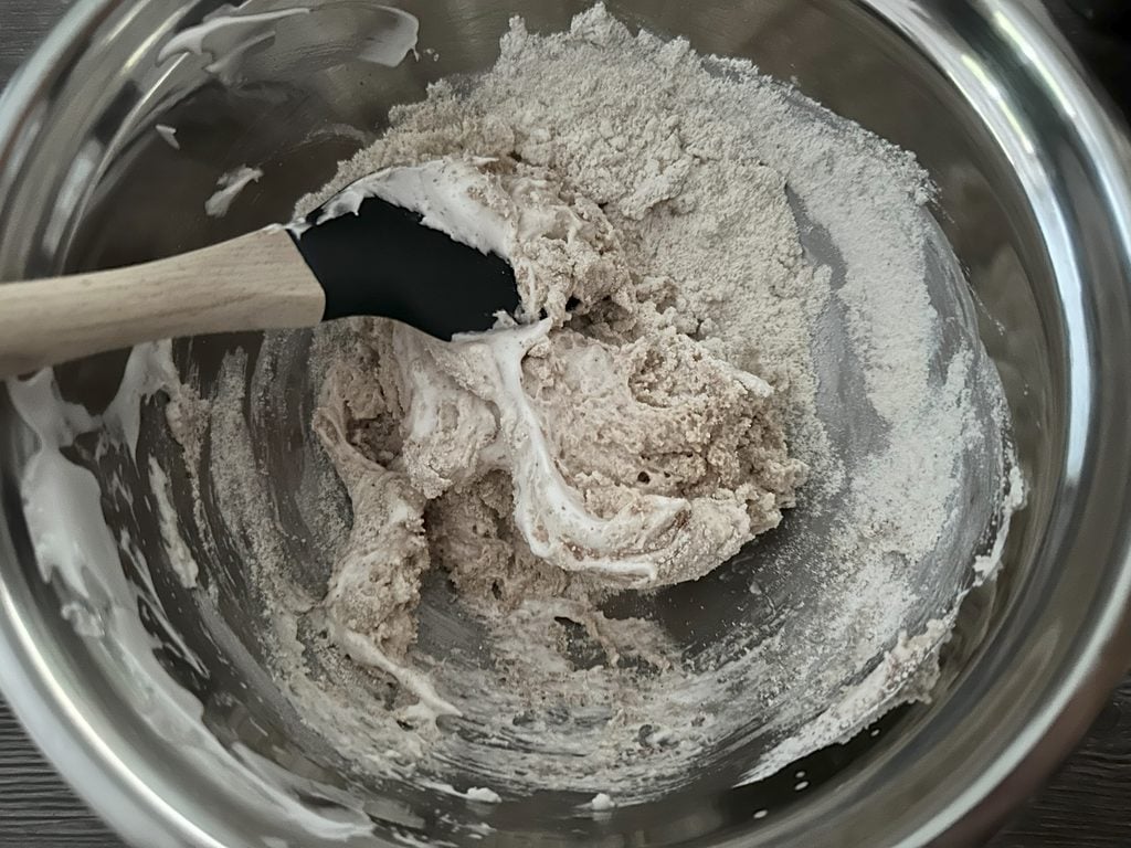 Mixing the meringue with the dry mixture.